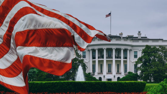 American flag waving in front of the White House