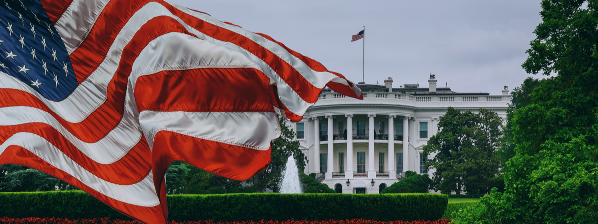 American flag waving in front of the White House