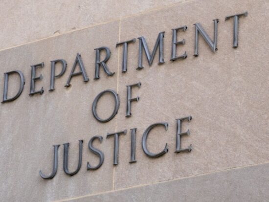 Sign at the United States Department of Justice DOJ in Washington, DC-Shutterstock_2262073553